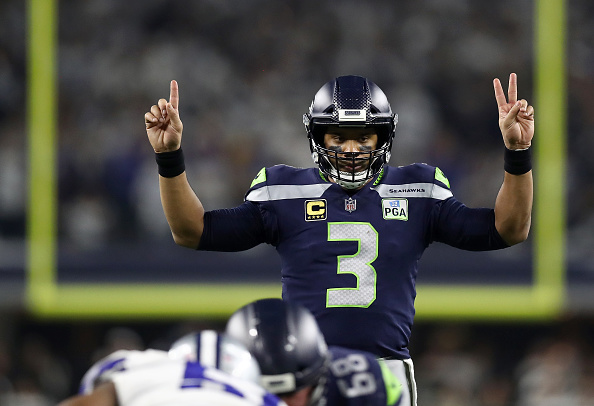 NFC West quarterback rankings - Russell Wilson signals before a play against the Dallas Cowboys