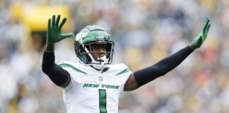 Sauce Gardner spreads his arms in celebration.