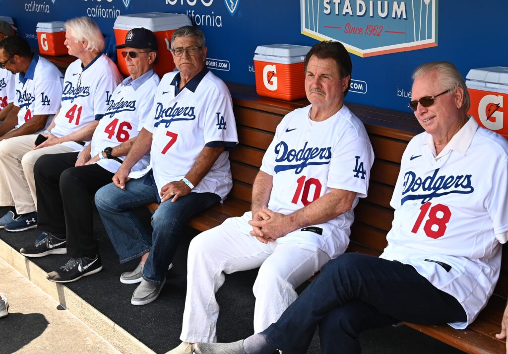 Jul 25, 2021; Los Angeles, California, USA; Los Angeles Dodgers Jerry Reuss, Burt Hooten, Steve Yeager, Ron Cey and Bill Russell sit in the dugout as they were honored during pregame ceremonies as members of the 40th anniversary of the 1981 World Series team at Dodger Stadium. Mandatory Credit: Jayne Kamin-Oncea-USA TODAY Sports