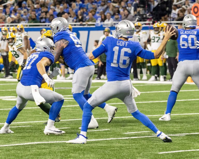 Detroit Lions Quarterback Jared Goff (16) in the historic throwbacks steps back to throw the ball to a receiver down field on Thanksgiving at Ford Field in Detroit, Michigan.