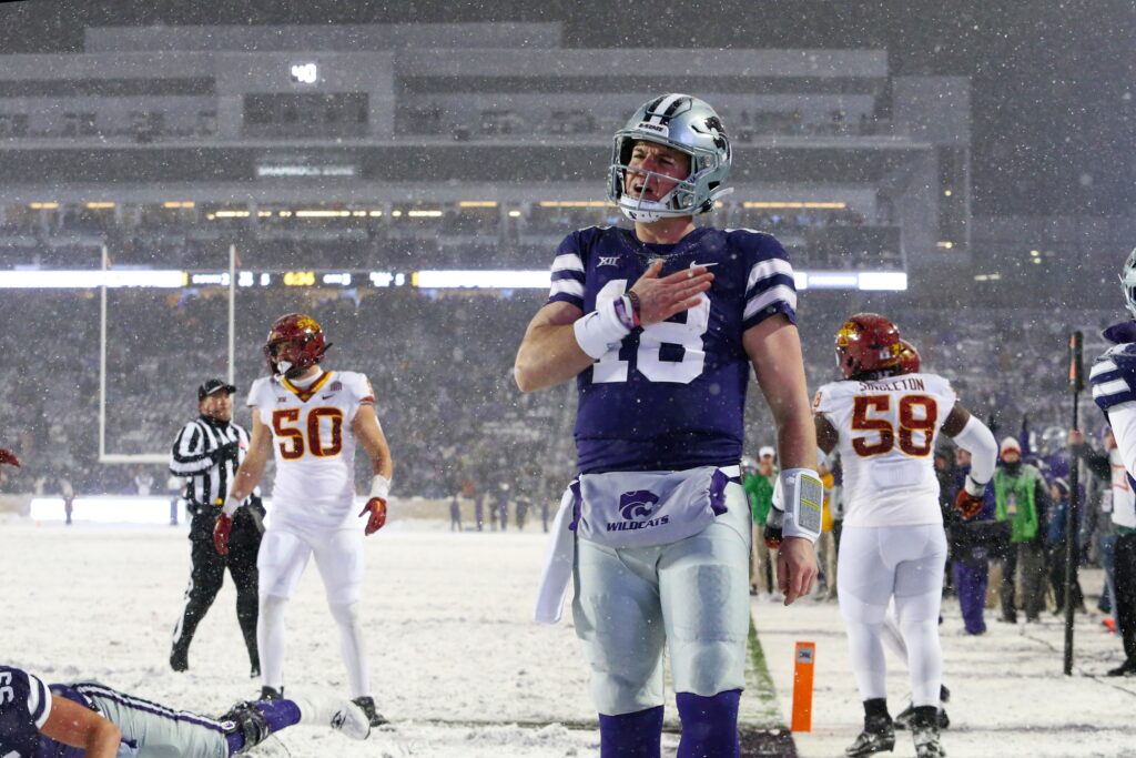 Kansas State Wildcats quarterback Will Howard (18) in a purple jersey celebrates a touchdown in the third quarter in a snow game in Manhattan, Kansas.