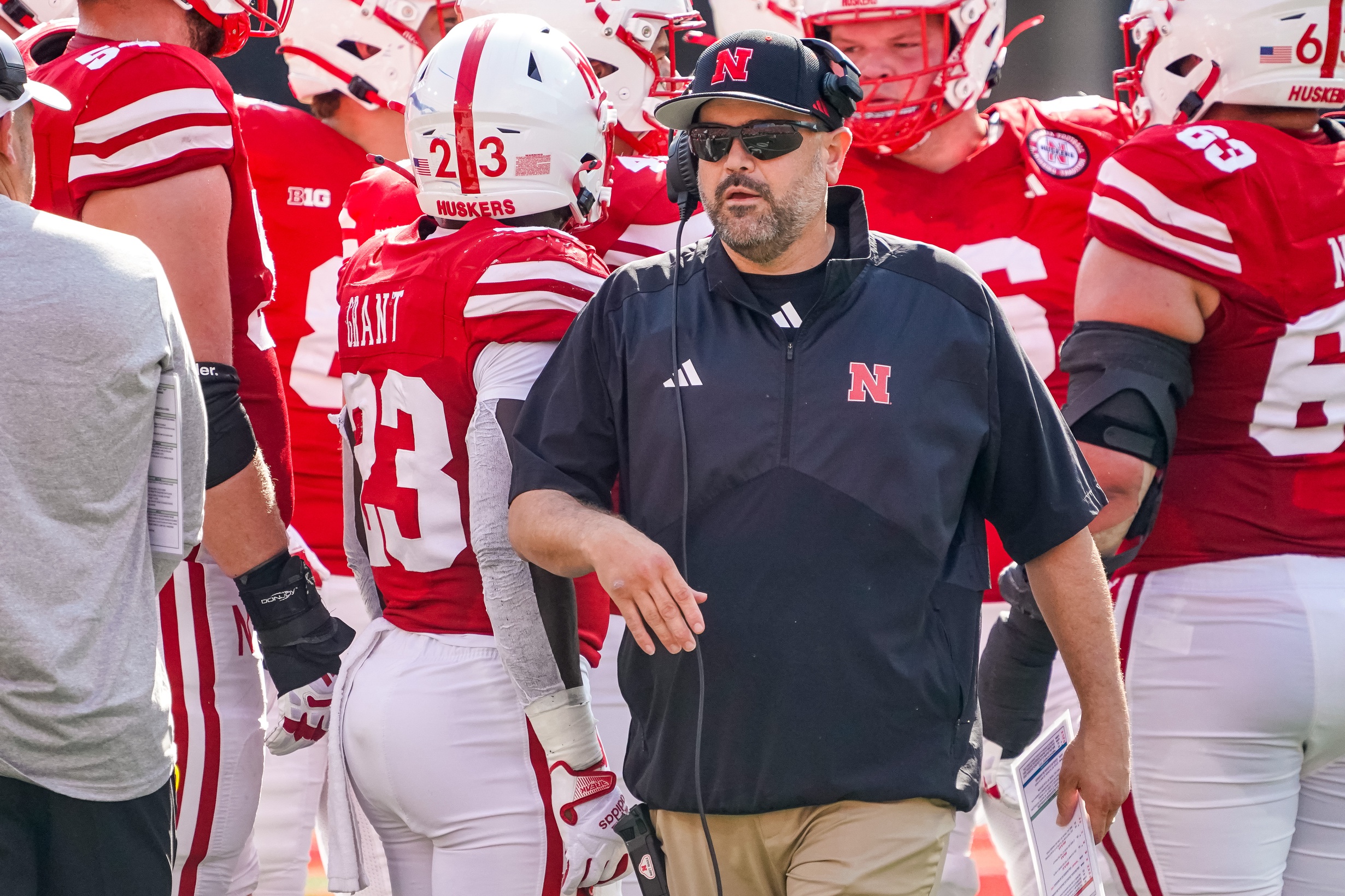 uskers head coach Matt Rhule walks out of a huddle during their game against the Michigan Wolverines during the first quarter at Memorial Stadium.
