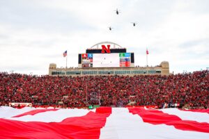 Three CH-47 Chinook helicopters fly over the field during the national anthem before the game between the Nebraska Cornhuskers and the Maryland Terrapins at Memorial Stadium. 