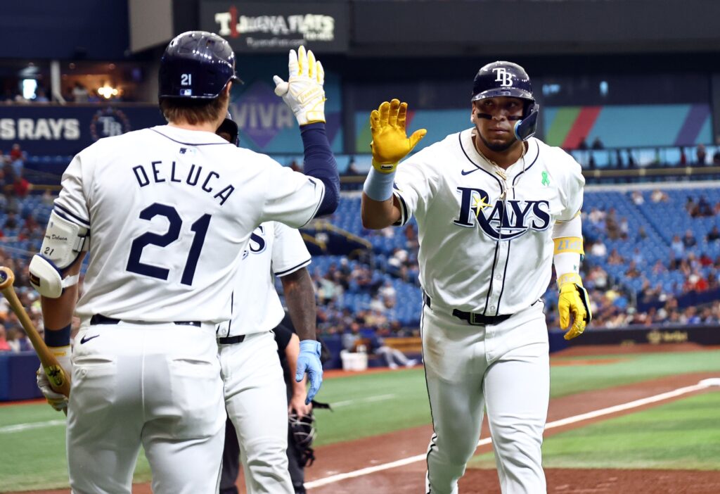 Tampa Bay Rays third baseman Isaac Paredes (17) is congratulated by outfielder Jonny DeLuca (21) after hitting a two-run home run against the Oakland Athletics during the first inning at Tropicana Field.