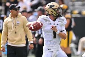 Head coach Ryan Walters watches Purdue quarterback Hudson Card warm up before matchup against the Iowa Hawkeyes. 