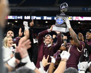 Dec 26, 2023; Detroit, MI, USA; Minnesota Golden Gophers running back Darius Taylor (1) and head coach P.J. Fleck hold up the Quick Lane Bowl trophy after defeating the Bowling Green Falcons at Ford Field. Photo by Lon Horwedel-USA TODAY Sports