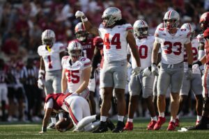 Ohio State Buckeyes defensive end JT Tuimoloau (44) celebrates a tackle of Indiana Hoosiers quarterback Tayven Jackson (2) during the NCAA football game at Indiana University Memorial Stadium. Ohio State won 23-3. 