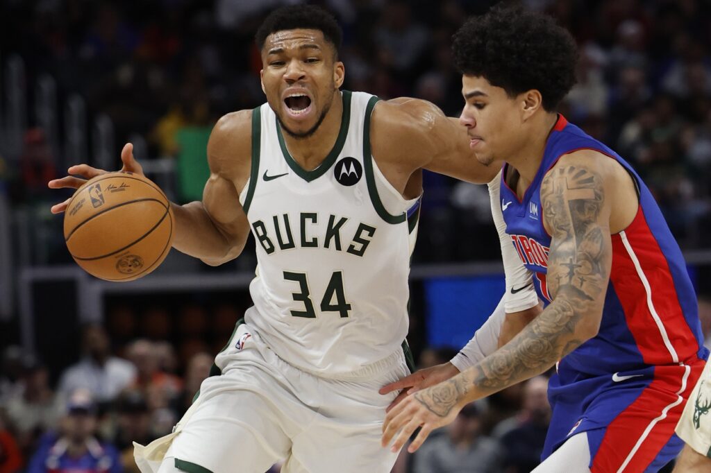 Milwaukee Bucks forward Giannis Antetokounmpo (34) dribbles defended by Detroit Pistons guard Killian Hayes (7) in the second half at Little Caesars Arena.