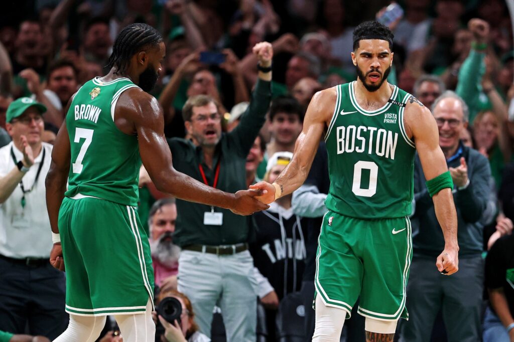 Boston Celtics forward Jayson Tatum (0) celebrates with guard Jaylen Brown (7) after a play against the Dallas Mavericks in game five of the 2024 NBA Finals at TD Garden.