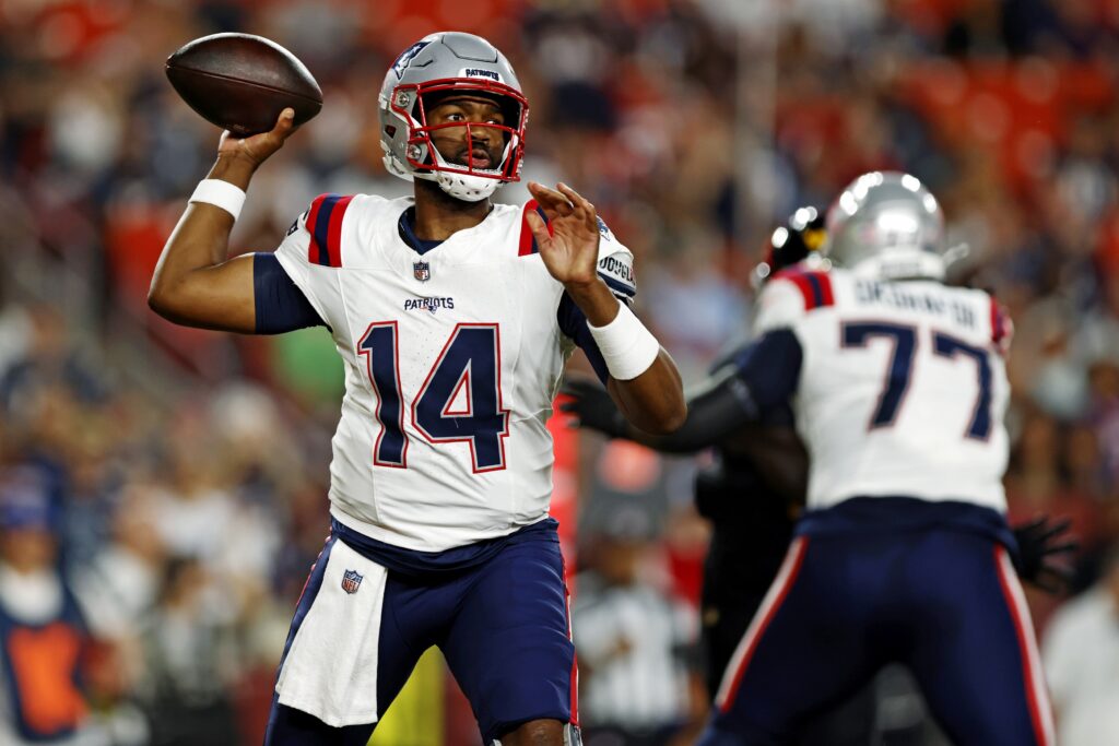 New England Patriots quarterback Jacoby Brissett (14) throws a pass during the first quarter against the Washington Commanders during a preseason game at Commanders Field.