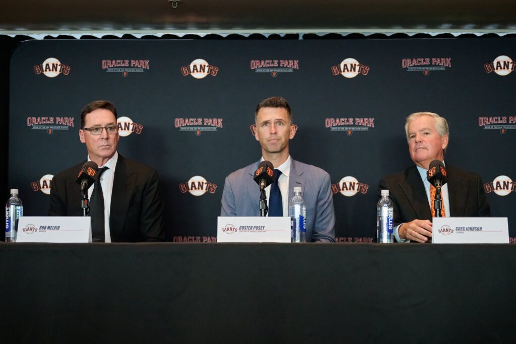 San Francisco Giants president of baseball operations Buster Posey (middle), manager Bob Melvin (left) and chairman Greg Johnson address the media during a press conference at Oracle Park.