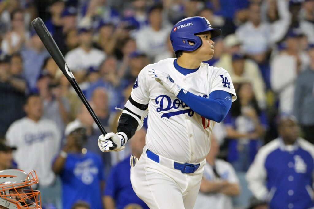 Los Angeles Dodgers designated hitter Shohei Ohtani (17) hits an RBI single in the sixth inning against the New York Mets during game six of the NLCS for the 2024 MLB playoffs at Dodger Stadium.